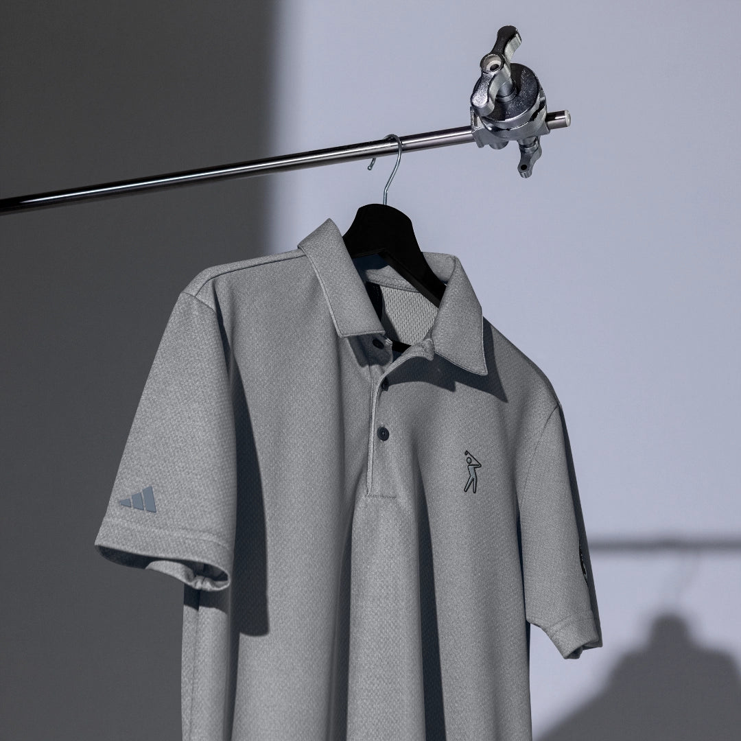 Space-Dyed Polo Shirt from YOLO Golf-adidas X Signature Black Edition in sleek gray with a modern fit. Features subtle branding and a stylish, contemporary design.